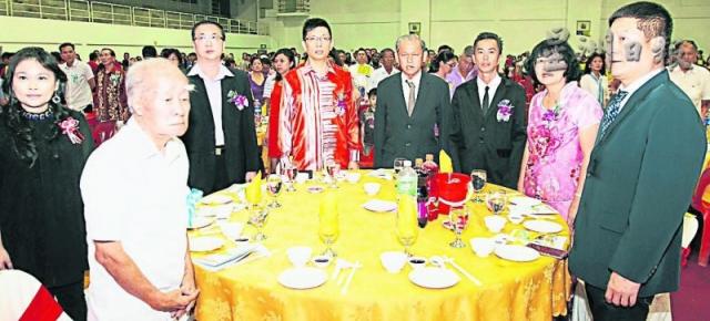 在启智华小爱华教义演上，嘉宾站立唱国歌。左起为骆华兴、陈瑞清、出德隆、陈金泉、郑心权、黄锦福、汤丽珠及李国全。